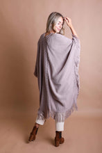 Load image into Gallery viewer, Model wearing the Tahoe open knit fringe ruana with white pants
